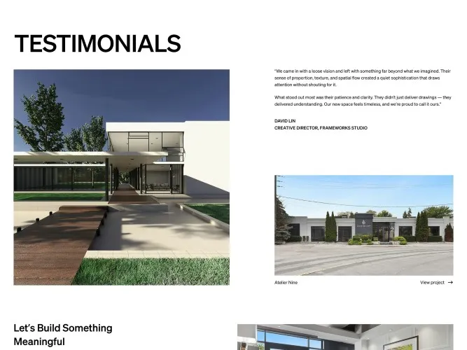 Modern minimalist house with glass walls, a wooden walkway, and surrounding green lawn under a clear blue sky.